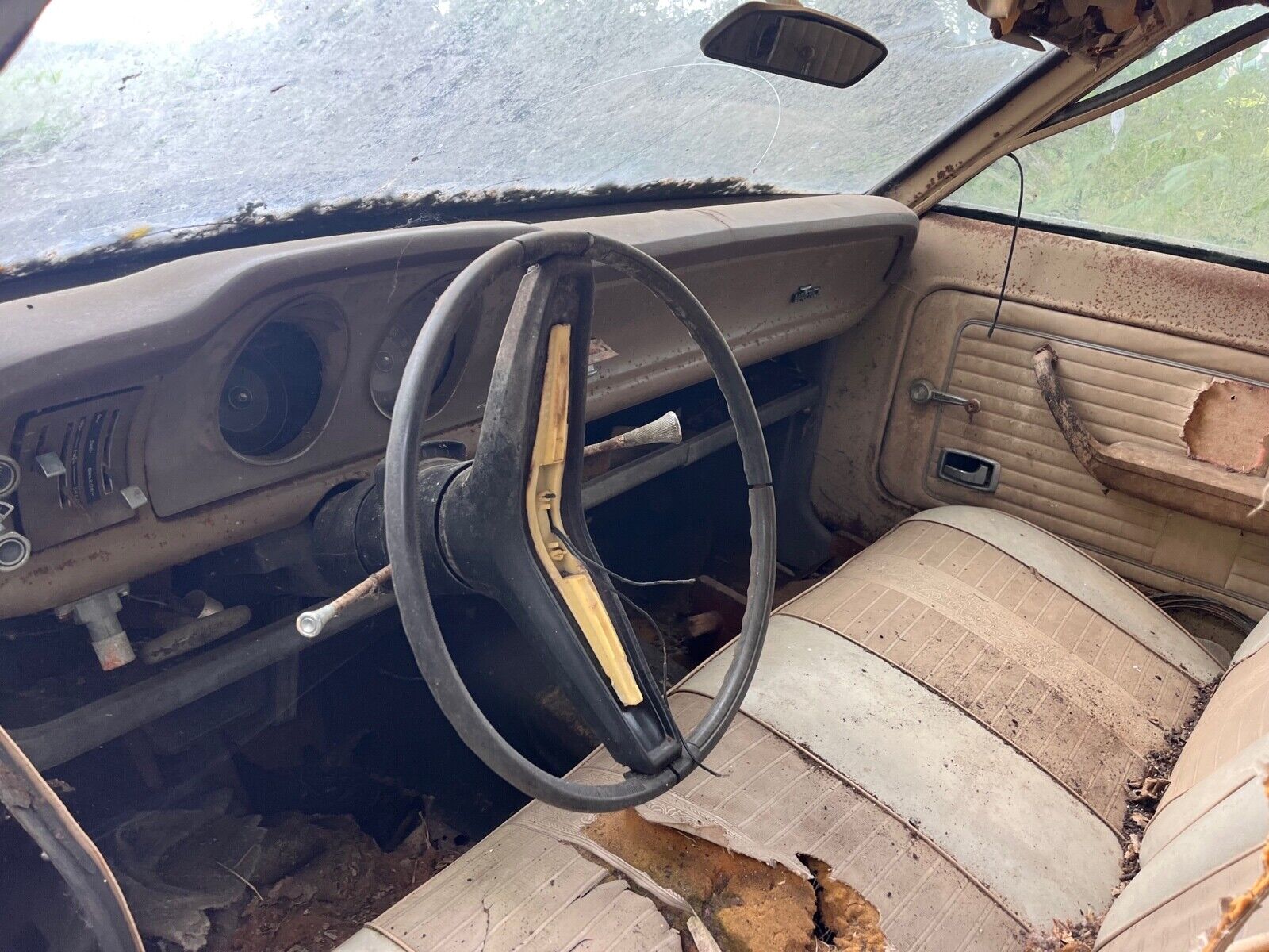 this 1973 ford was forgotten in a barn that fell apart now abandoned in the woods 13