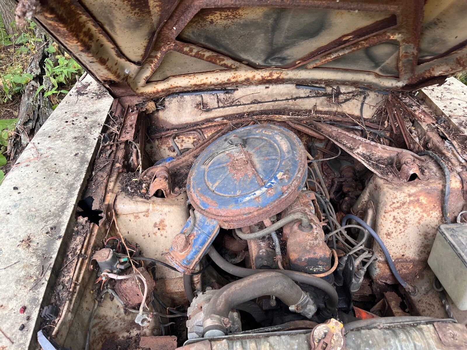 this 1973 ford was forgotten in a barn that fell apart now abandoned in the woods 14